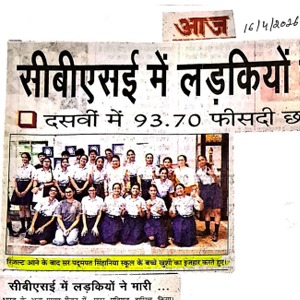 Hindi newspaper clipping showing a group of girls posing for a photo beneath a bold headline about girls in a program or event.