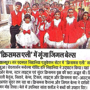Group of children in red costumes with white beards posing for a photo at a Christmas event.