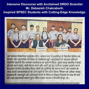 Group photo of SPSEC students with DRDO scientist Mr. Debasish Chakraborty during an intensive discourse, on a blue-framed page with a Hindi article beneath.