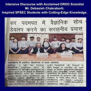 Newspaper clipping showing a group of students posing with a DRDO scientist after a science discourse; Hindi headline and blue border banner.