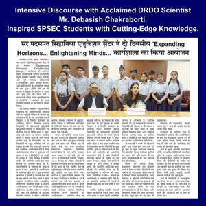Newspaper clipping showing a group of students with a DRDO scientist during a signing ceremony, reporting on an inspirational talk for SPSEC students.