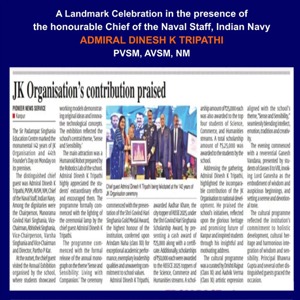 Newspaper clipping with the headline 'JK Organisation’s contribution praised', featuring a small group photo of officials receiving or presenting an award; a blue banner at the top lists dignitaries, including Admiral Dinesh K. Tripathi.