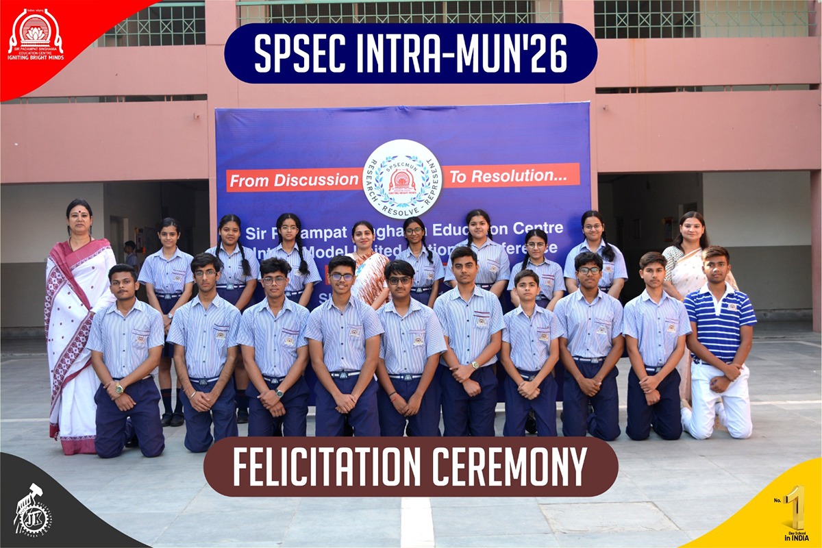 Group of students in blue uniforms posing at a felicitation ceremony for SPSEC INTRA-MUN'26.