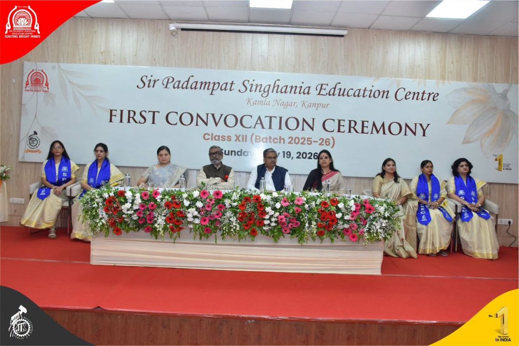 A First for Kanpur SPSEC Celebrates Its First Convocation Ceremony Panel of dignitaries and graduates seated on a stage behind a long flower-filled table at the Sir Padampat Singhania Education Centre's First Convocation Ceremony image.