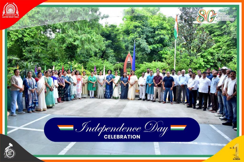 Celebrating the Spirit of Freedom Independence Day at SPSEC Group of staff posing outdoors for Independence Day celebration; banner reads 'Independence Day Celebration' with Indian flags in the background.