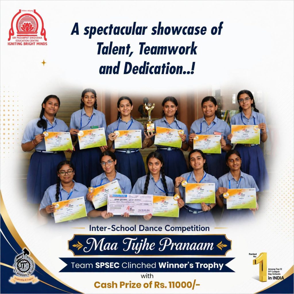 SPSEC Wins Maa Tujhe Pranaam Inter-School Dance Competition Group of smiling female students in uniforms holding certificates and a trophy at a school awards poster.